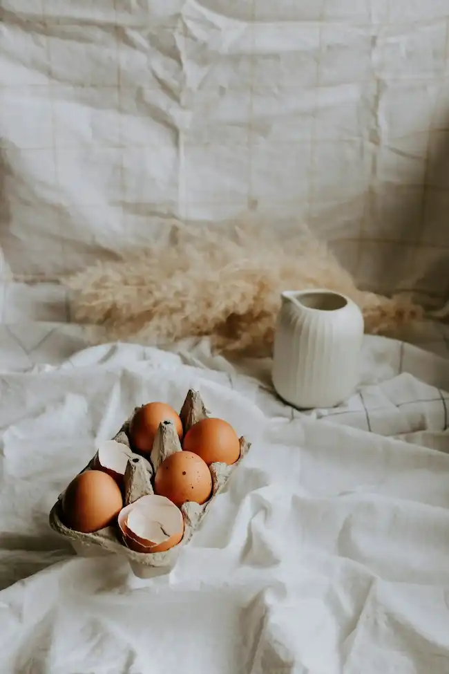 Step-by-step process showing eggs being lowered into boiling water with slotted spoon